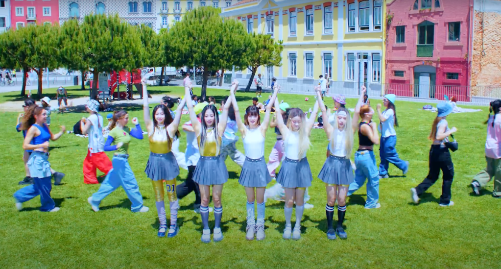 Cena do grupo NewJeans de mãos dados na música Super Shy do álbum Get Up