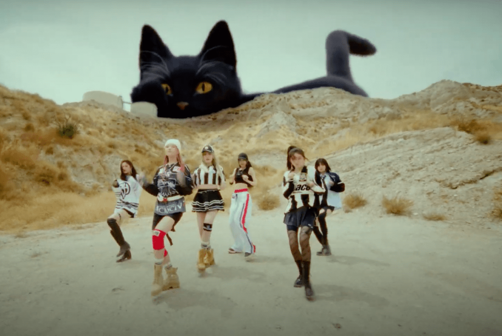 Cena do MV de "Baddie", uma das três titletracks do álbum I've Mine do IVE com as meninas dançando e um gato preto gigante no fundo