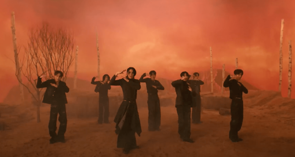 Cena do MV de "BIBORA" do álbum Sequence com os membros do SF9 dançando em um cenário todo laranja