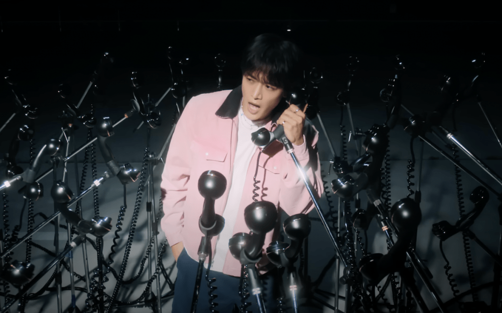 Cena do MV de "Call Back", que marca o comeback do Minho do SHINee com seu primeiro álbum. Minho está cercado por telefones