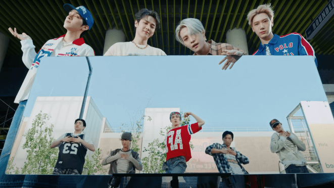 Cena do MV de "BIG BANDS", novo comeback do WayV com os cinco dançando dentro de um outdoor