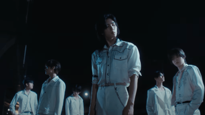 Cena do MV de LOST com os membros do LUN8 vestidos de branco em um cenário escuro