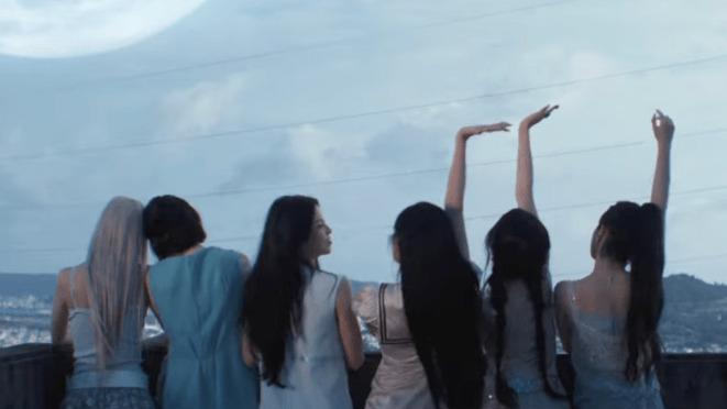 Review do álbum Heavy Serenade do NMIXX: cena do MV da title com Bae, Haewon, Jiwoo, Kyujin, Lily e Sullyoon de costas para a câmera